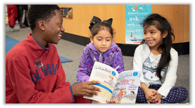 Student shares the joy of reading with younger students